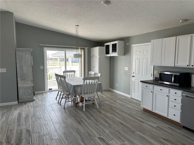 948 Wissota Green Pkwy, Chippewa Falls, WI 54729 - dining space with baseboards, a textured ceiling, and dark wood-type flooring