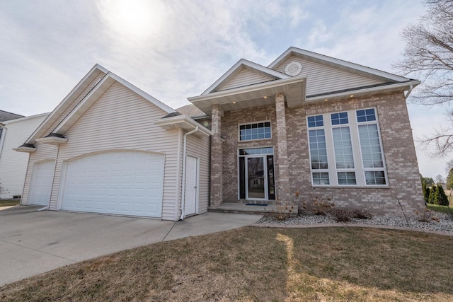201 E Clearfield Ln, Appleton, WI 54913 - view of front of property with driveway, brick siding, a garage, and a front lawn
