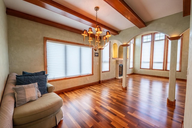 201 E Clearfield Ln, Appleton, WI 54913 - living room featuring wood finished floors, baseboards, a chandelier, a glass covered fireplace, and beamed ceiling