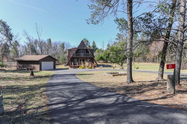 317 Darby Ct, Nekoosa, WI 54457 - a-frame home with driveway, an outdoor structure, a front yard, and a garage