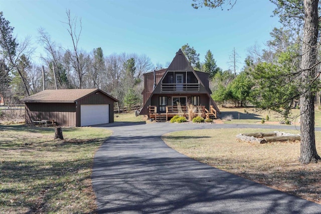 317 Darby Ct, Nekoosa, WI 54457 - a-frame home featuring an outdoor structure, a wooden deck, a front yard, and a garage
