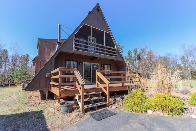 317 Darby Ct, Nekoosa, WI 54457 - rear view of property with cooling unit, a balcony, a deck, and board and batten siding