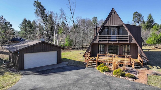317 Darby Ct, Nekoosa, WI 54457 - a-frame style home with a balcony, board and batten siding, a wooden deck, an outdoor structure, and a garage