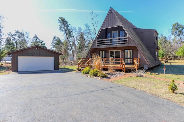 317 Darby Ct, Nekoosa, WI 54457 - a-frame home with a balcony, board and batten siding, a wooden deck, an outbuilding, and a garage