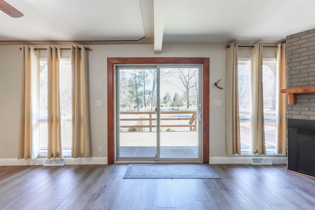 317 Darby Ct, Nekoosa, WI 54457 - entryway featuring beam ceiling, wood finished floors, visible vents, and a fireplace