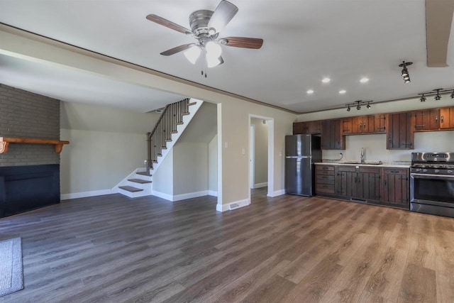 317 Darby Ct, Nekoosa, WI 54457 - kitchen with a sink, ceiling fan, light countertops, gas stove, and freestanding refrigerator