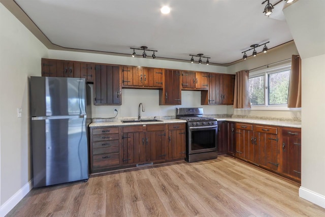 317 Darby Ct, Nekoosa, WI 54457 - kitchen with a sink, baseboards, light wood-style floors, light countertops, and appliances with stainless steel finishes