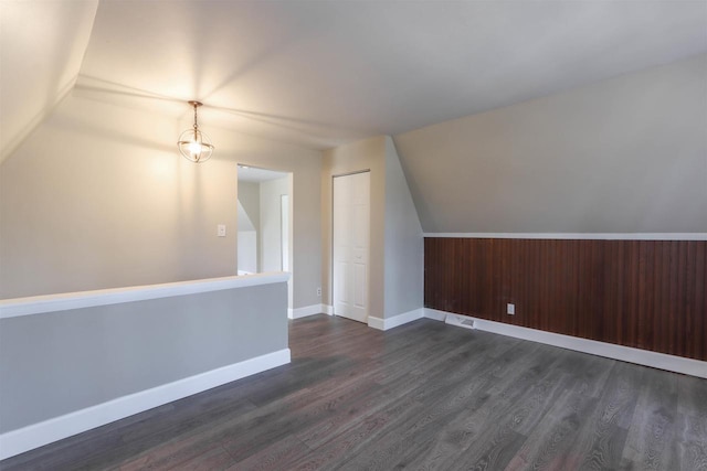 317 Darby Ct, Nekoosa, WI 54457 - bonus room featuring dark wood-type flooring, vaulted ceiling, visible vents, and baseboards