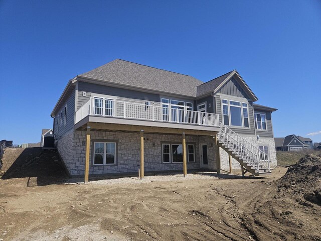 1618 White Deer Trl, Waukesha, WI 53189 - back of property featuring stone siding, a wooden deck, board and batten siding, and stairway