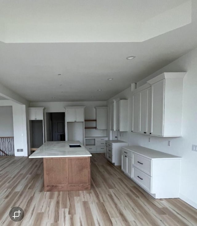 1618 White Deer Trl, Waukesha, WI 53189 - kitchen with recessed lighting, a kitchen island, light wood finished floors, and white cabinetry