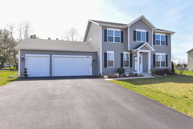 430 Ashley Dr, Williams Bay, WI 53191 - colonial home with a front lawn, aphalt driveway, and an attached garage