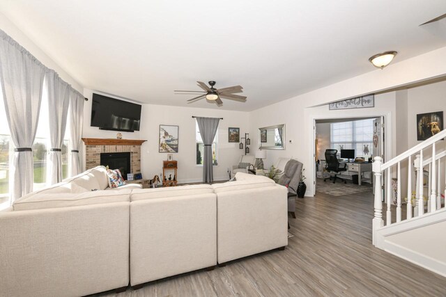430 Ashley Dr, Williams Bay, WI 53191 - living area featuring light wood-type flooring, a ceiling fan, and a brick fireplace