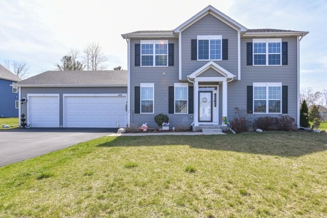 430 Ashley Dr, Williams Bay, WI 53191 - view of front of house with aphalt driveway, a garage, and a front yard