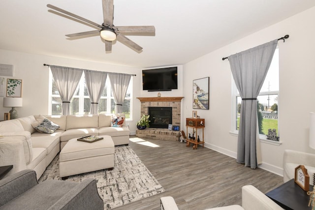 430 Ashley Dr, Williams Bay, WI 53191 - living room featuring baseboards, a ceiling fan, wood finished floors, and a fireplace