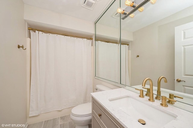 110 W St Unit 1, Lake Geneva, WI 53147 - bathroom with visible vents, toilet, vanity, and shower / bathtub combination with curtain