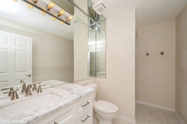 110 W St Unit 1, Lake Geneva, WI 53147 - bathroom with tile patterned flooring, toilet, vanity, and baseboards