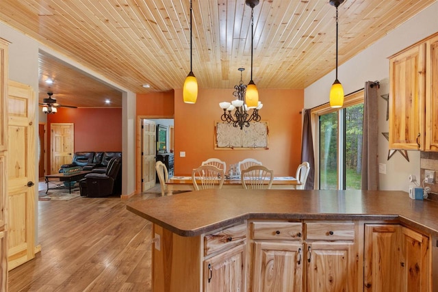 1686 Archer Ave, Nekoosa, WI 54457 - kitchen with a peninsula, wooden ceiling, dark countertops, pendant lighting, and light wood-style flooring