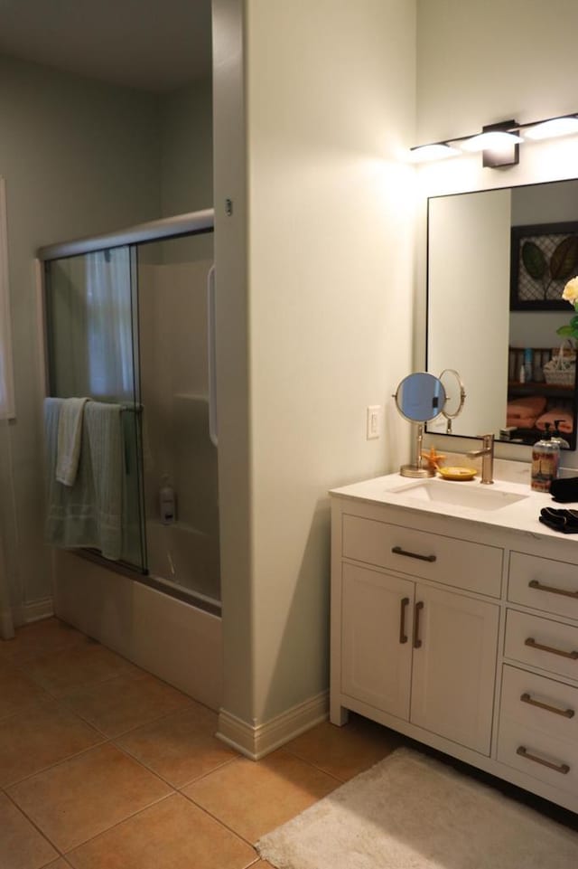 2917 Bridlepath Ct, Lake Geneva, WI 53147 - full bathroom featuring tile patterned floors, vanity, shower / bath combination with glass door, and baseboards
