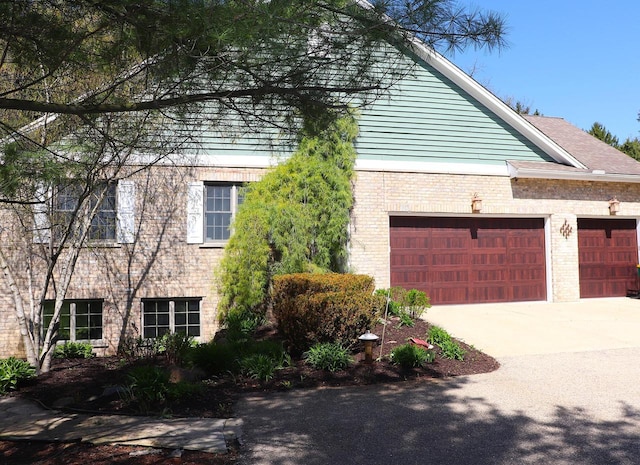 2917 Bridlepath Ct, Lake Geneva, WI 53147 - view of side of property featuring an attached garage, brick siding, and concrete driveway