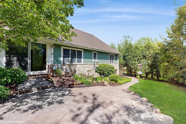2917 Bridlepath Ct, Lake Geneva, WI 53147 - view of front of property featuring a patio, a front yard, and a shingled roof