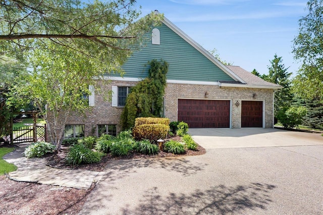 2917 Bridlepath Ct, Lake Geneva, WI 53147 - view of side of property with an attached garage, driveway, and brick siding