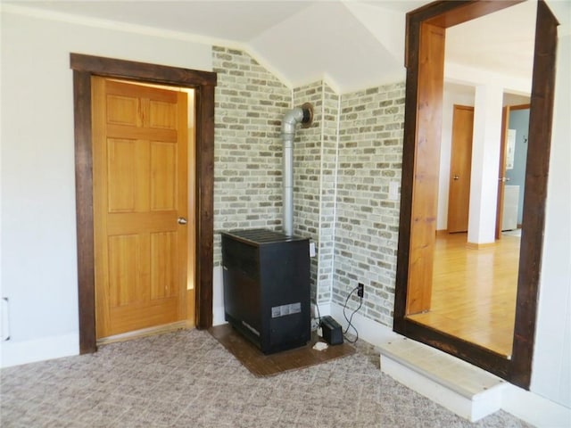 interior space with baseboards and a wood stove