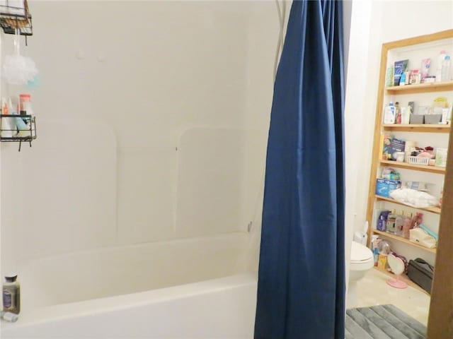 bathroom featuring shower / bath combo and toilet