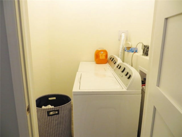 clothes washing area featuring washer and dryer and laundry area