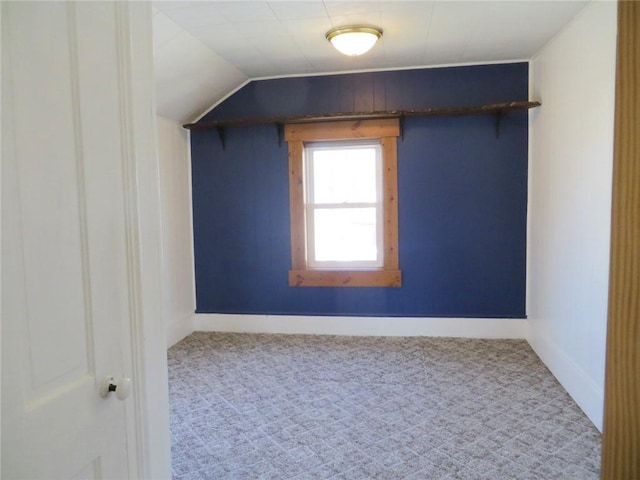 bonus room with baseboards and carpet flooring