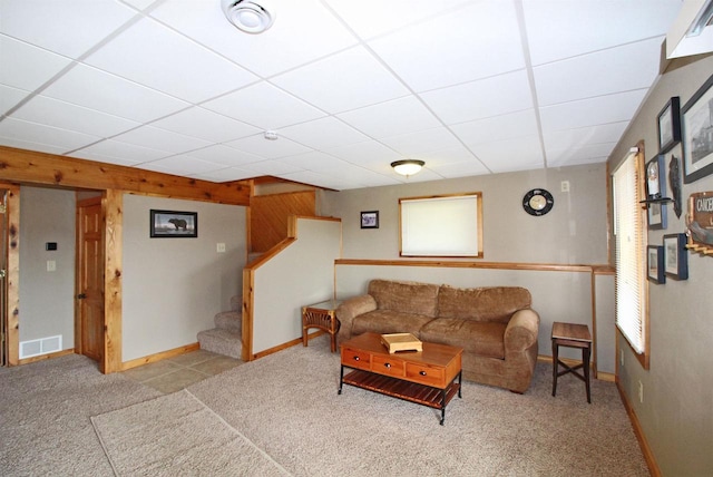 living room featuring stairway, a drop ceiling, visible vents, carpet floors, and baseboards