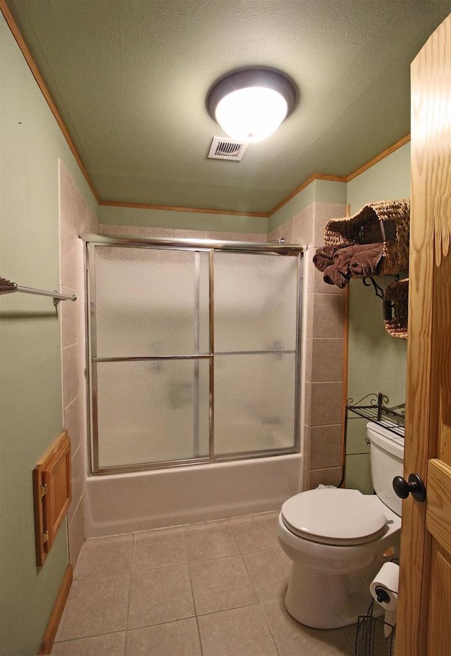 bathroom with shower / bath combination with glass door, tile patterned flooring, visible vents, toilet, and ornamental molding
