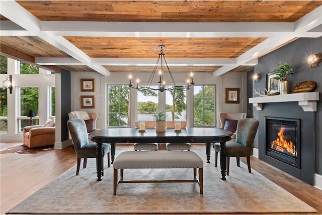 1211 172nd Ave, Balsam Lake, WI 54810 - dining area with a chandelier, a glass covered fireplace, wood finished floors, and a wood ceiling with exposed beams