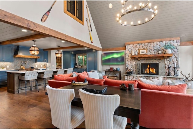 1211 172nd Ave, Balsam Lake, WI 54810 - living room with dark wood-style floors, a chandelier, high vaulted ceiling, and a stone fireplace