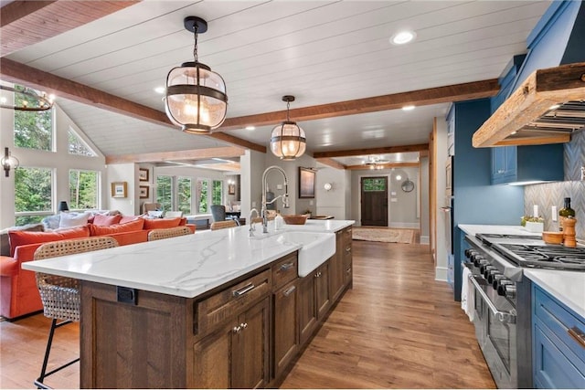 1211 172nd Ave, Balsam Lake, WI 54810 - kitchen with wood finished floors, open floor plan, a breakfast bar area, double oven range, and recessed lighting