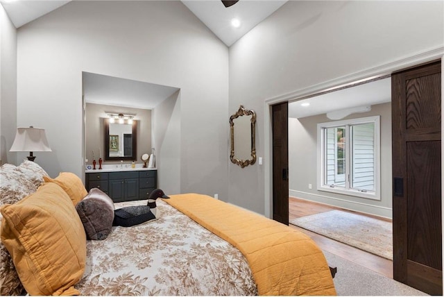 1211 172nd Ave, Balsam Lake, WI 54810 - bedroom featuring wood finished floors, ensuite bathroom, high vaulted ceiling, and recessed lighting