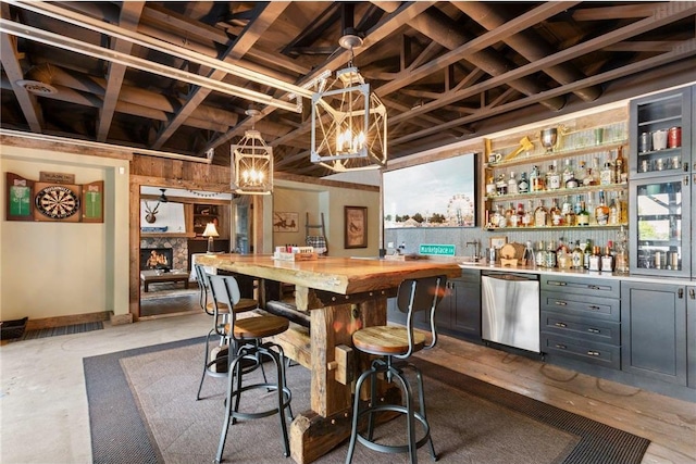 1211 172nd Ave, Balsam Lake, WI 54810 - indoor wet bar featuring stainless steel dishwasher, a chandelier, pendant lighting, and a fireplace