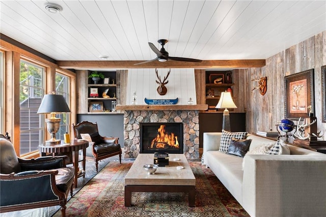 1211 172nd Ave, Balsam Lake, WI 54810 - living room with a fireplace, a ceiling fan, wood walls, and built in shelves
