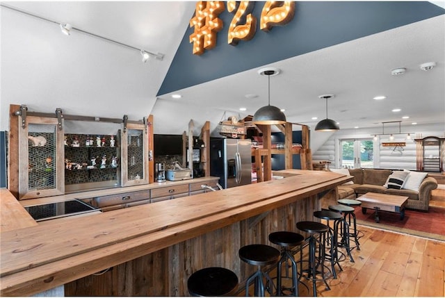 1211 172nd Ave, Balsam Lake, WI 54810 - community bar area featuring stainless steel fridge, light wood finished floors, decorative light fixtures, recessed lighting, and a chandelier
