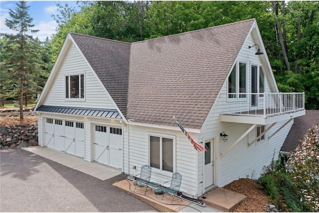 1211 172nd Ave, Balsam Lake, WI 54810 - view of front of house with a shingled roof, a balcony, and a standing seam roof
