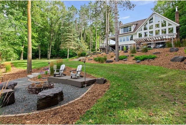 1211 172nd Ave, Balsam Lake, WI 54810 - view of green lawn with an outdoor fire pit and a wooden deck