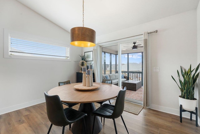 dining room with a wealth of natural light, wood finished floors, and baseboards