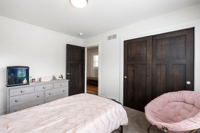 bedroom featuring carpet, visible vents, and a closet