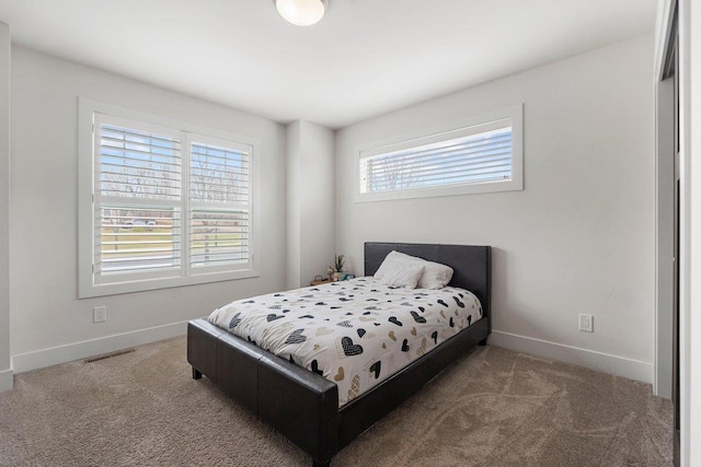 bedroom featuring baseboards and carpet