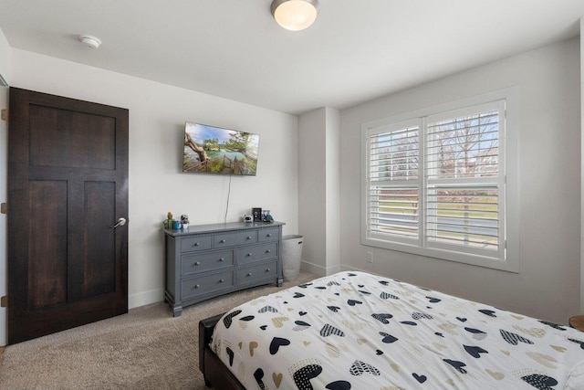 bedroom with light carpet and baseboards