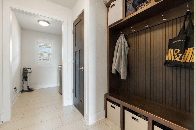 mudroom featuring water heater and baseboards