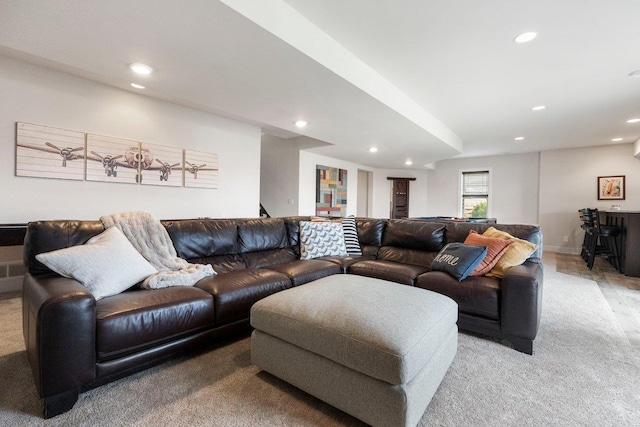 living area featuring light carpet and recessed lighting