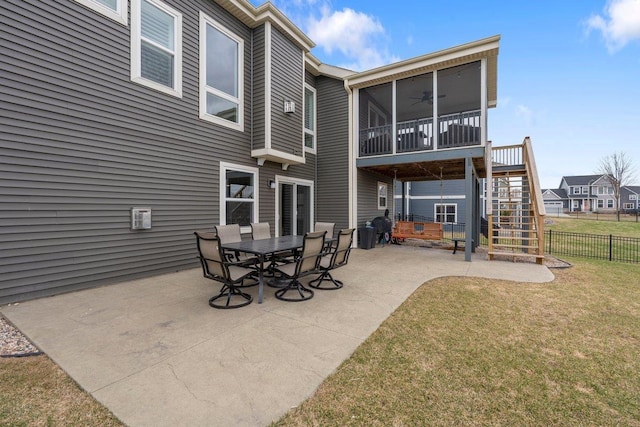 rear view of property with a ceiling fan, stairs, fence, a yard, and a patio area