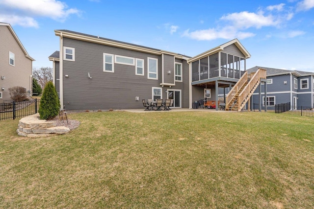 rear view of house featuring fence, a patio area, a sunroom, and stairs