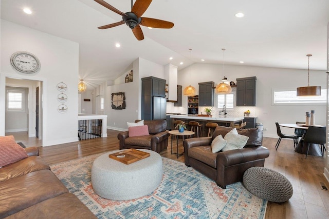 living area with recessed lighting, wood finished floors, and a ceiling fan