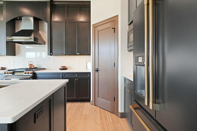 8437 Creek View Ln, Mount Pleasant, WI 53406 - kitchen featuring wall chimney range hood, decorative backsplash, appliances with stainless steel finishes, and light wood-style flooring